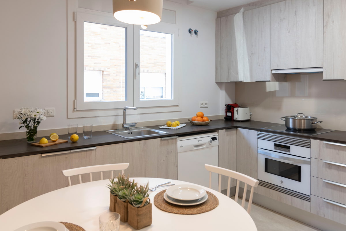 Fully equipped kitchen with dishwasher, oven, toaster, and Nespresso coffee machine.