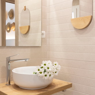 Countertop washbasin and modern mirrors in the bathroom of one of our apartments in Calafell.