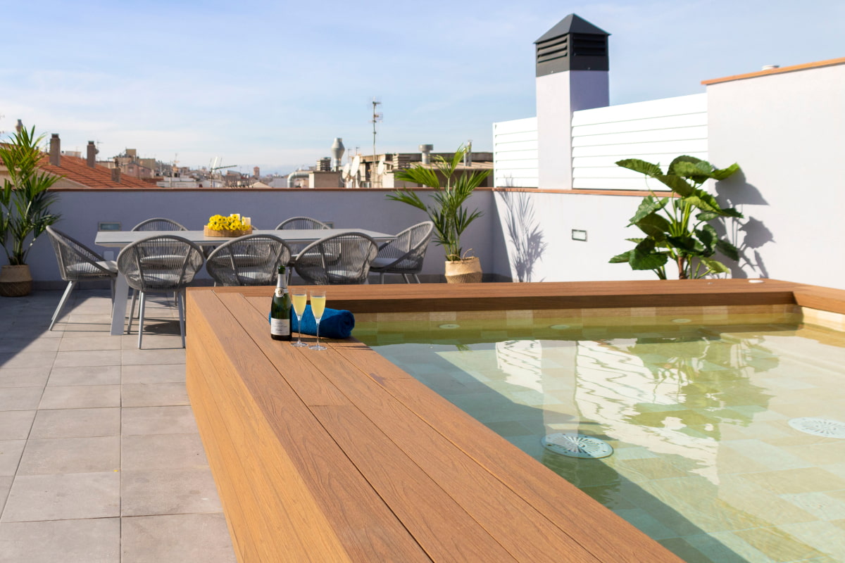 Another angle of the upper terrace with a table and chairs next to the jacuzzi pool.