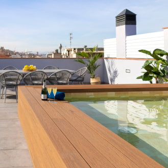 Another angle of the upper terrace with a table and chairs next to the jacuzzi pool.