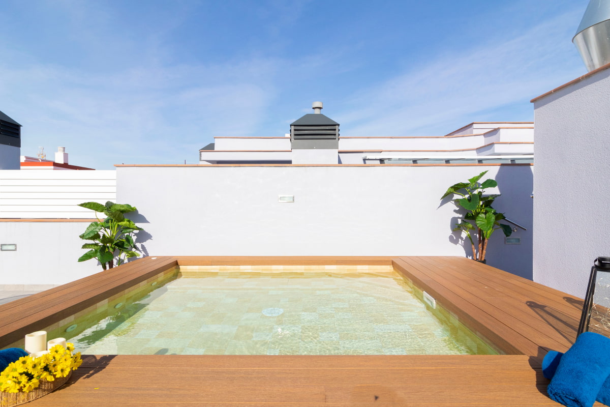 Jacuzzi pool surrounded by wooden decking.