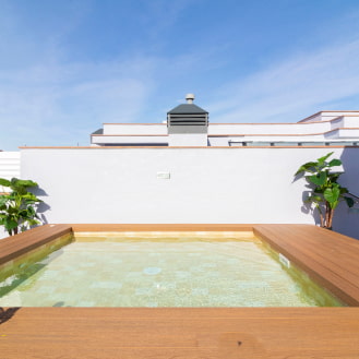 Jacuzzi pool surrounded by wooden decking.