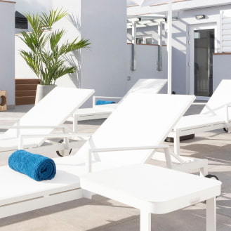 Close-up of the white sun loungers in our solarium.